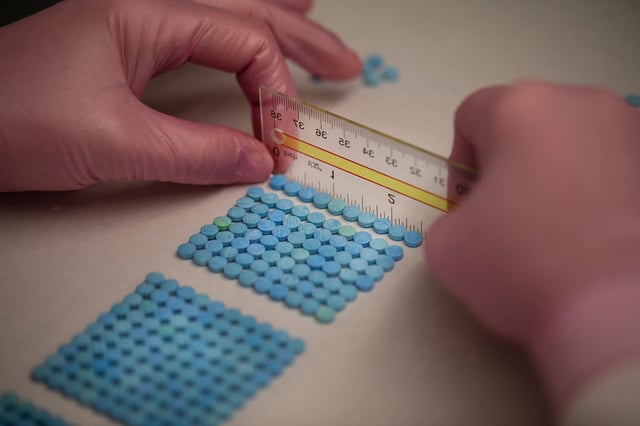 Laura Kimble, senior drug chemist and forensic scientist with the Hamilton County CoronerÕs Crime Laboratory located in Blue Ash, counts out fake oxycodone in the Blue Ash-based lab in 2022.