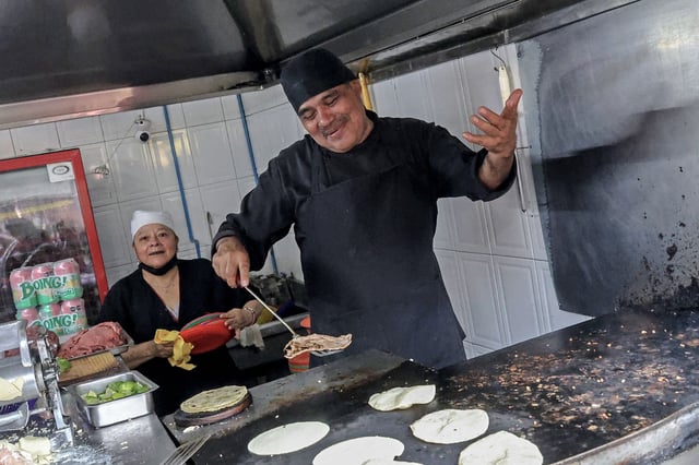 Chef Arturo Rivera Martinez prepares tacos at Taqueria El Califa de Leon restaurant in Mexico City on May 15, 2024. A hole-in-the-wall taqueria is among the first restaurants in Mexico to be awarded a star by the prestigious Michelin Guide -- an accomplishment its owner credits to "love and effort".