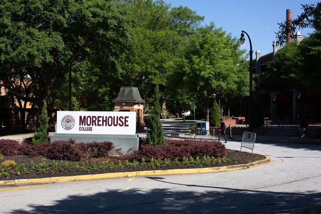 A person walks by the sign for Morehouse College in Atlanta on May 1, 2023.