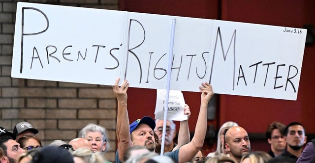 California’s Jurupa Unified School District Board on Monday approved a $360,000 settlement agreement for a Christian teacher fired for refusing to use preferred pronouns or lie to parents about their child’s gender identity. Pictured: The same issues played out about 13 miles west in Chino, California, last summer. A parental rights supporter holds up a sign during a Chino Valley Unified School District board meeting in Chino on July 20. The school district was to vote on a parental notification policy requiring schools to notify parents if their child changes his or her pronouns. (Photo: Will Lester/ Media News Group/Inland Valley Daily Bulletin/Getty Images)