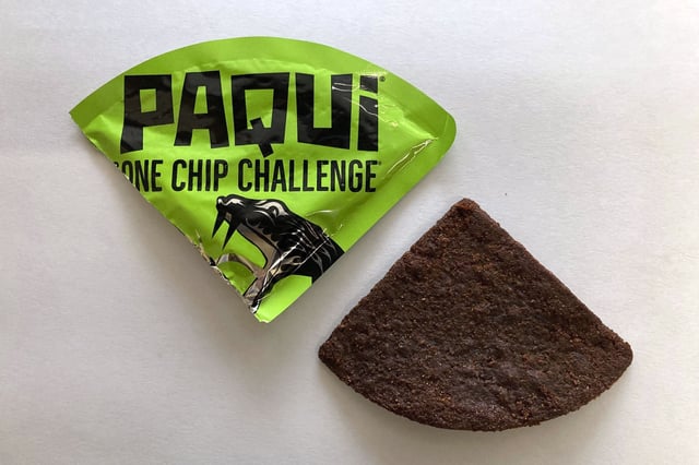 A Paqui One Chip Challenge chip is displayed in Boston, Friday, Sept. 8, 2023. A medical examiner says a Massachusetts teen who participated in a spicy tortilla chip challenge died from ingesting a substance “with a high capsaicin concentration,” according to autopsy results The Associated Press obtained late Wednesday, May 15, 2024. Capsaicin is a chili pepper extract. Harris Wolobah died on Sept. 1, 2023, after eating the chip.
