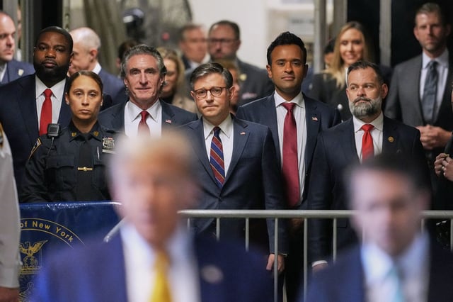 US Representative Byron Donalds, Republican of Florida, Governor of North Dakota Doug Burgum, US Speaker of the House Mike Johnson, former presidential candidate Vivek Ramaswamy and US Representative Cory Mills, Republican of Florida, listen as former President Donald Trump speaks to reporters as he arrives to attend his trial for allegedly covering up hush money payments linked to extramarital affairs, at Manhattan Criminal Court in New York City, on May 14, 2024.