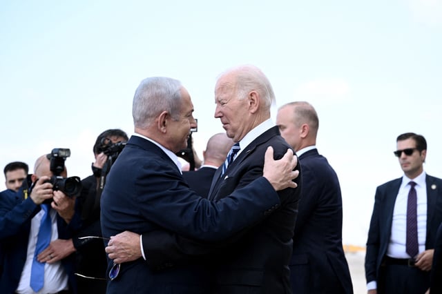 Israeli Prime Minister Benjamin Netanyahu greets President Joe Biden upon his arrival in Tel Aviv on Oct. 18. Hamas' brutal attack on Israel earlier that month has led to severe reprisals that have resulted in the deaths of tens of thousands of people in Gaza.