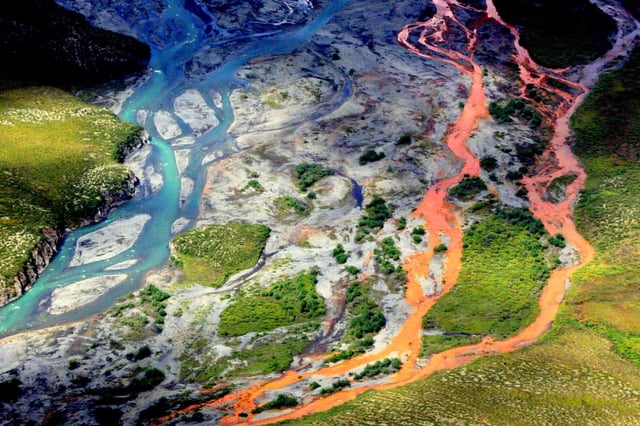 An aerial view of the rust-colored Kutuk River in Gates of the Arctic National Park in Alaska. Thawing permafrost is exposing minerals to weathering, increasing the acidity of the water, which releases metals like iron, zinc and copper