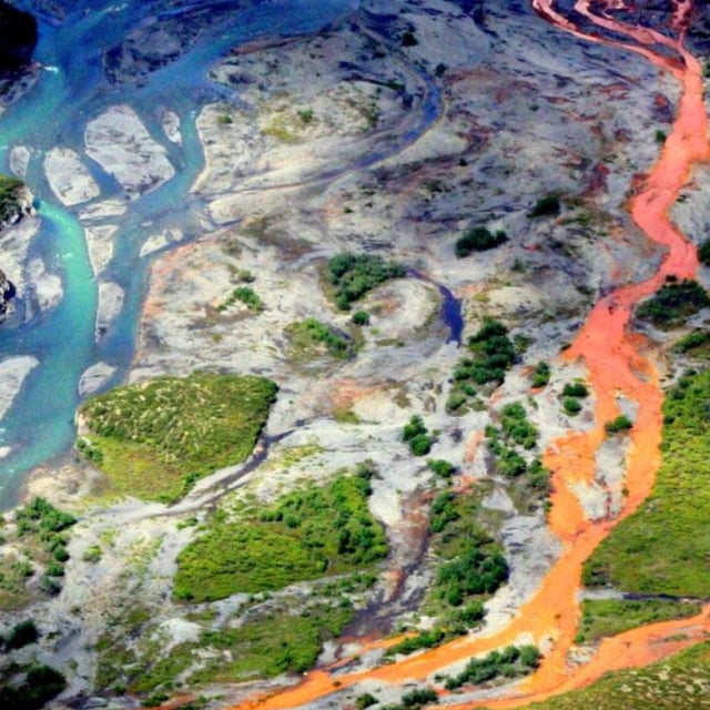 An aerial view shows the rust-colored Kutuk River in the Arctic National Park in Alaska. Researchers found that permafrost is causing minerals to break down in the water, leading to acidity and increased levels of metals.
