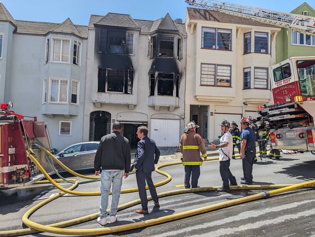 San Francisco Fire Department officials respond to a fire at Terry Williams' home in the 900 block of Grove Street on Tuesday, May 21, 2024. Williams, a longtime resident and dog walker in Alamo Square, says packages containing racist materials started showing up at his front door last month.