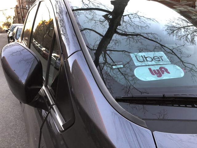 Uber and Lyft sign in windshield of car, Queens, New York. (Photo by: Lindsey Nicholson/Education Images/Universal Images Group via Getty Images)