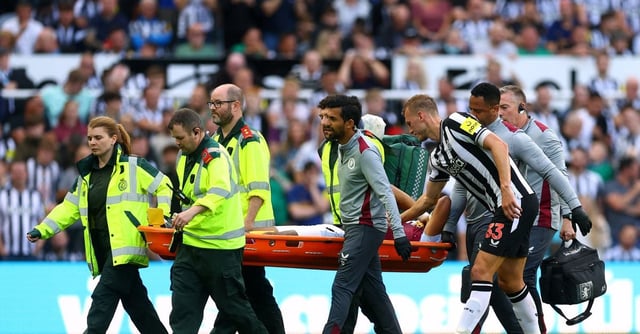 Soccer Football - Premier League - Newcastle United v Aston Villa  - St James' Park, Newcastle, Britain - August 12, 2023 Aston Villa's Tyrone Mings is carried off the pitch in a stretcher after sustaining an injury Action Images via Reuters/Lee Smith