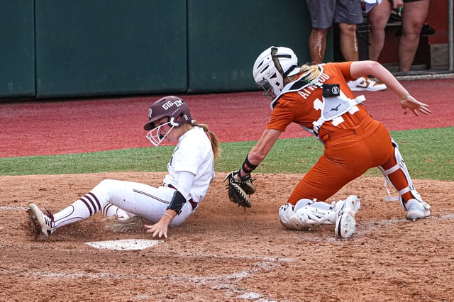 Texas A&M outfielder Hailey Golden (9) slides past Texas Longhorns catcher Reese Atwood (14) for a score during the NCAA Super Regional opener at Red & Charline McCombs Field on Friday, May 24, 2024 in Austin.