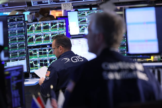 Traders work on the floor of the New York Stock Exchange during morning trading on Jan. 31 2024 in New York City.