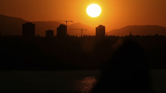 FILE - The sun sets over the University District in Seattle, May 13, 2023, seen from 520 Bridge View Park in Medina, Wash. A hazardous heat wave is expected to bring scorching temperatures to the Pacific Northwest this week, Monday, Aug. 14, according to the National Weather Service. (AP Photo/ Lindsey Wasson, File)