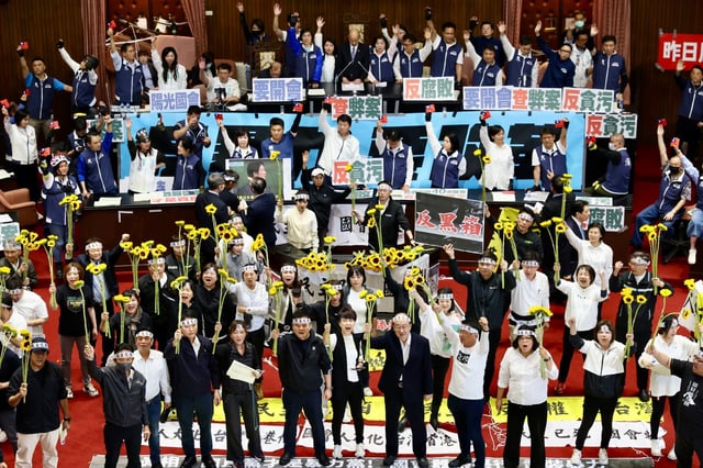 DPP lawmakers react to the opposition’s proposed reforms in the Taiwanese legislature on Tuesday, urging clause-by-clause deliberation of bills aimed at increasing scrutiny on William Lai’s administration. Photo: EPA