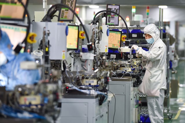 SIYANG, CHINA - MARCH 01: Employees operate machines at a dust-free workshop of a semiconductor factory on March 1, 2023 in Siyang County, Suqian City, Jiangsu Province of China. (Photo by VCG/VCG via Getty Images)