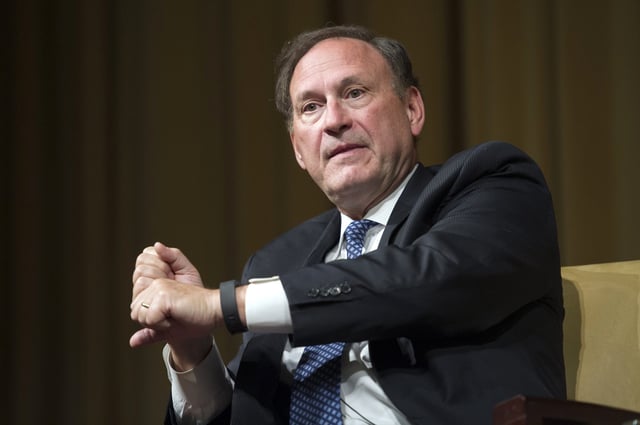Clobbering voting rights. Here, Justice Samuel Alito explains a baseball batter's swing at the National Archives in Washington, Oct. 29, 2015.