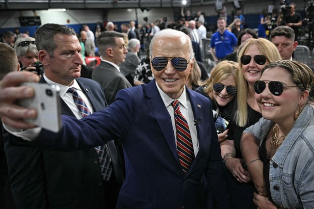 President Joe Biden takes a selfie with supporters after speaking at an event in Nashua, N.H., on May 21, 2024.