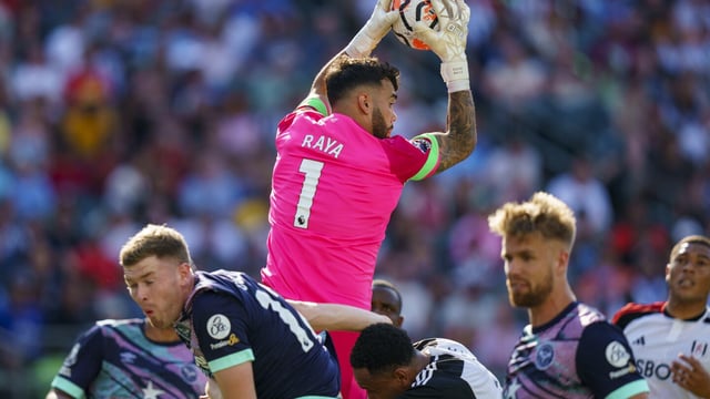 Brentford's David Raya (1) leaps above the scrum to grab the ball during the second half of an English Premier League Summer Series soccer match against Fulham, Sunday, July 23, 2023 in Philadelphia. (AP Photo/Chris Szagola)