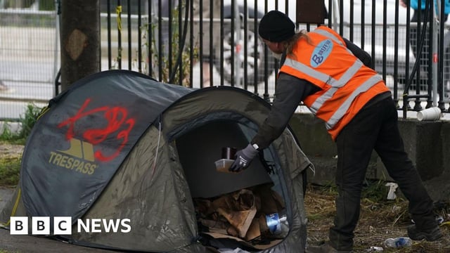 Volunteer removing tents