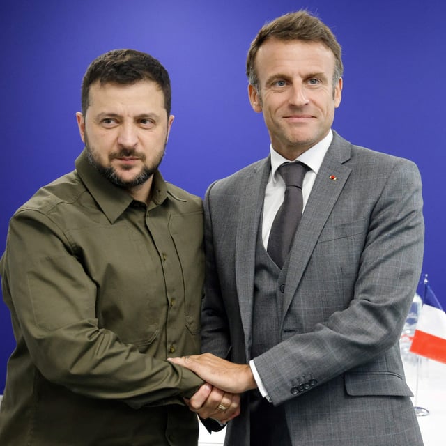 Ukraine's President Volodymyr Zelensky (L) shakes hands with French President Emmanuel Macron as they arrive to take part in a bilateral meeting during the European Political Community summit at the Palacio de Congreso in Granada, southern Spain on October 5, 2023. France could send instructors to Ukraine to train the military in a matter of days, according to reports.