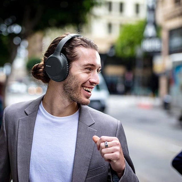 A man wearing the Sony-WHCH710N/B over ear headphones.