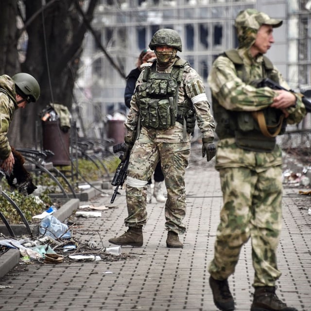 Russian soldiers walks along a street in Mariupol, Ukraine, on April 12, 2022. Russian forces in Ukraine lost 38,940 fighters last month, Ukraine's Defense Ministry said on Saturday, marking what Ukraine described as the "highest monthly number since the beginning of the full-scale invasion."