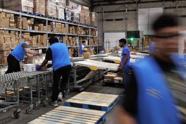 Employees organize inventory as they are unloaded from a delivery truck at a Walmart store in Grand Prairie, Texas, US, on Thursday, April 25, 2024. In an effort to boost retention, Walmart has sweetened pay and stock incentives for its store managers, whose individual locations employ hundreds and can exceed $100 million in annual sales. Photographer: Shelby Tauber/Bloomberg via Getty Images