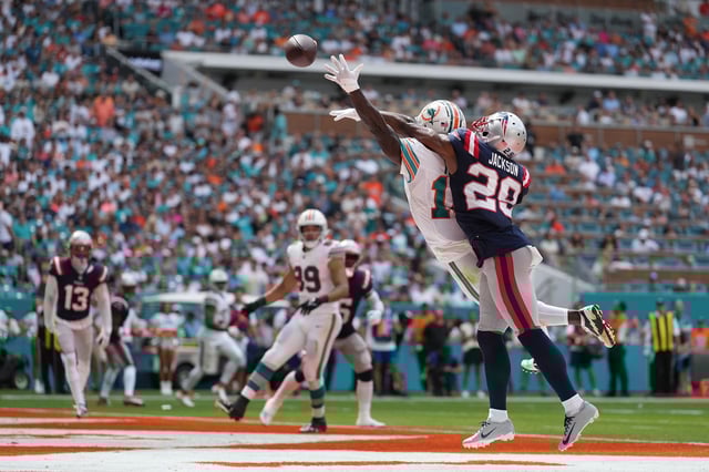 Miami Dolphins wide receiver Tyreek Hill (10) can't reach the ball but New England Patriots cornerback J.C. Jackson (29) gets flagged on the call during the game between the New England Patriots and the Miami Dolphins on Sunday, October 29, 2023 at Hard Rock Stadium, Miami Gardens, Fla.