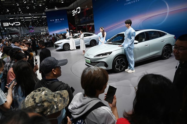 Crowds gather to view BYD electric cars at the Beijing Auto Show on May 3, 2024.
