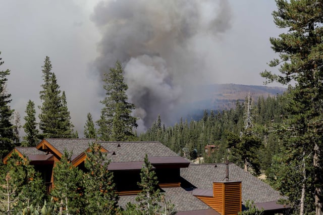 Smoke from the Caldor Fire rises over a ridge in Kirkwood (Alpine County) in 2021. Wildfire smoke is responsible for tens of thousands of premature deaths in California, researchers say.