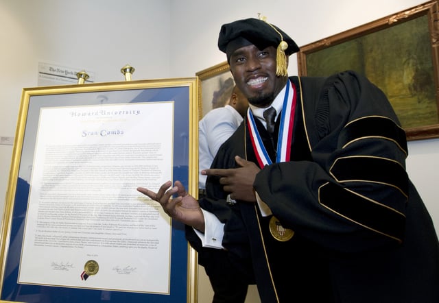 FILE - Entertainer and entrepreneur Sean Combs poses next to his honorary degree of Doctor of Humanities during the graduation ceremony at Howard University in Washington, Saturday, May 10, 2014. In a decision, Friday, June 7, 2024, Howard University is cutting ties to Combs, rescinding the honorary degree that was awarded to him and disbanding a scholarship program in his name. (AP Photo/Jose Luis Magana, File)