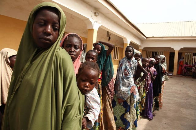 Girls rescued by Nigerian soldiers from Islamist militants Boko Haram at Sambisa Forest line up to collect donated clothes at the Malkohi refugee camp in Yola on May 5, 2015.