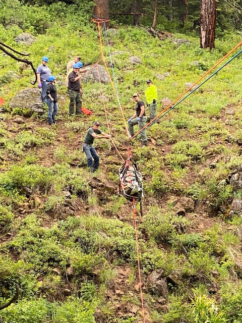 Rescuers recover Brandon Garrett the day after his car went down an embankment and one of his dogs alerted his family that Garrett needed help.