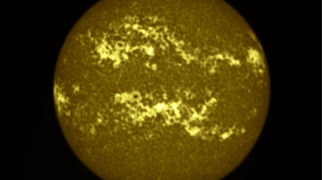 a fuzzy dark yellow and brownish orb in a black abyss.