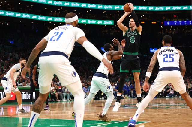 Kristaps Porziņģis shoots against the Dallas Mavericks during the first quarter in Game 2 of the 2024 NBA Finals.