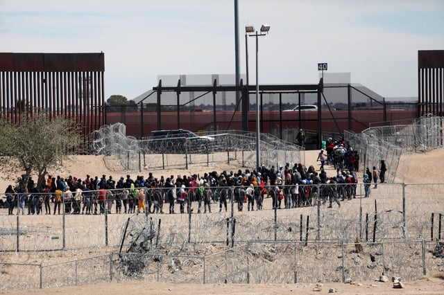 Migrants wait to be transferred by U.S. Border Patrol after having crossed the Bravo River in El Paso, Texas, on April 18, 2024. 
