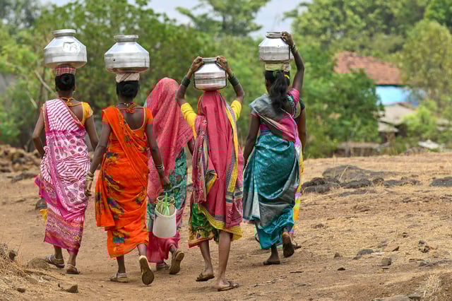 In this photo taken on May 26, 2024, villagers carry water pots in Shahapur district of India's Maharashtra state, amid ongoing heatwave. (Photo by Indranil MUKHERJEE / AFP) (Photo by INDRANIL MUKHERJEE/AFP via Getty Images)