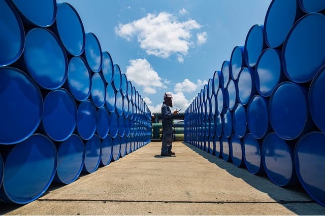 Male worker inspection record drum oil stock barrels blue horizontal or chemical for in industry