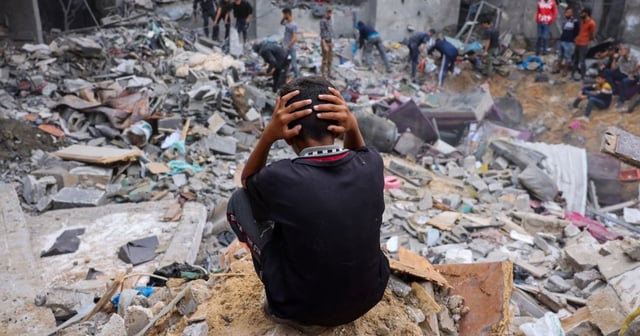 eople salvage belongings amid the rubble of a damaged building following strikes on Rafah in the southern Gaza Strip, November 12, 2023.