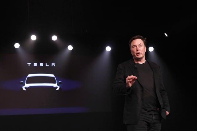 Elon Musk, co-founder and chief executive officer of Tesla Inc., speaks during an unveiling event for the Tesla Model Y crossover electric vehicle in Hawthorne, California, U.S., on Friday, March 15, 2019. Musk said the cheaper electric crossover sports utility vehicle (SUV) will be available from the spring of 2021. The vehicle's price will start at $39,000, a longer-range version will cost $47,000. Photographer: Patrick T. Fallon/Bloomberg via Getty Images