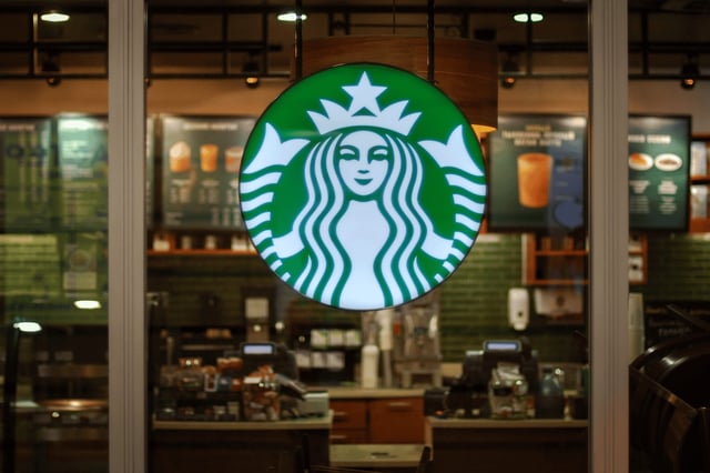 Starbucks logo in front of a window