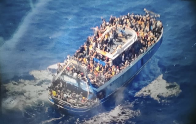 FILE - In this undated photo provided by Greece's coast guard on Wednesday, June 14, 2023, scores of people sit on a battered fishing boat that later capsized and sank off southern Greece. The sinking of the Adriana a year ago in international waters 75 kilometers (45 miles) off southern Greece was one of the worst of its kind in the Mediterranean Sea. Only 82 bodies were recovered, so hundreds of families still lack even the grim satisfaction of certitude that their relatives are dead. (Hellenic Coast Guard via AP, File)
