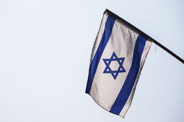 An Israeli flag is seen at the entrance to a school in Kibbutz Amir near Israel's border with Lebanon, in northern Israel, October 10, 2023. REUTERS/Lisi Niesner