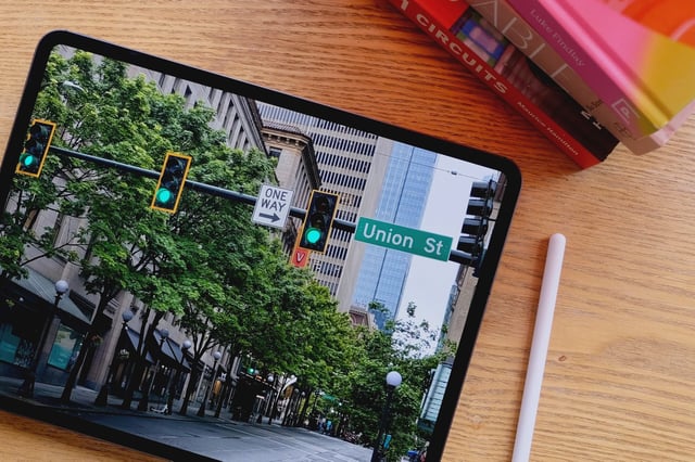 Apple M4 iPad Pro laid out on a table with a pen next to it