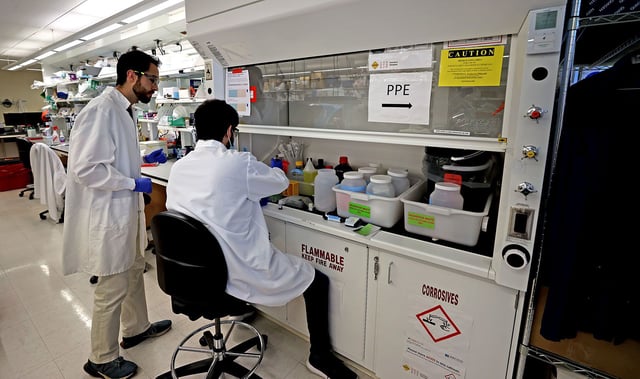 Cambridge, MA - May 14: From left, Jon Arizti Sanz, PhD, Postdoctoral Fellow with  Liam Alec Stenson Ortiz, research associate working in the lab. The Broad institute, Sabeti Lab is testing purchased milk at area grocery stores for the presence of bird flu. (Photo by David L. Ryan/The Boston Globe via Getty Images)