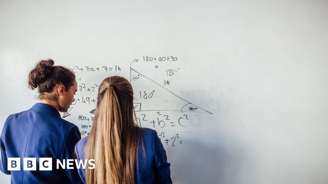 Students doing maths on a whiteboard