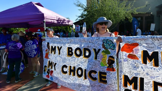 Women hold a sign at a protest in the district of Republican state Representative Matt Gress after Arizona's Supreme Court revived a law dating to 1864 that bans abortion in virtually all instances. REUTERS/Caitlin O’Hara