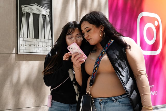 Women walk along Michigan Avenue in the Magnificent Mile shopping district  on May 30, 2024 in Chicago.