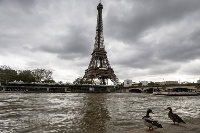 The River Seine runs past the Eiffel Tower in Paris on April 11, 2024.