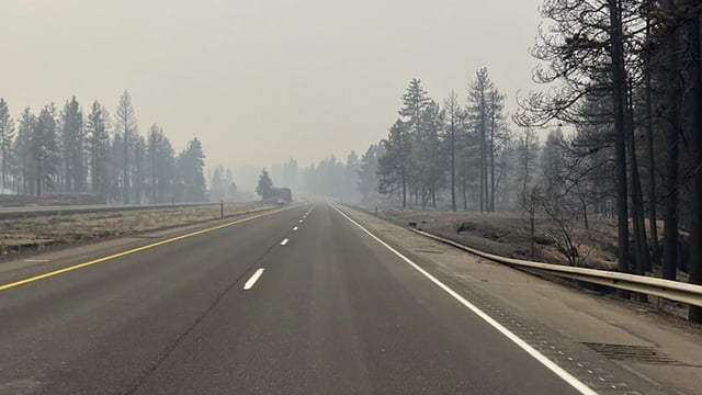 FILE - This photo provided by WSDOT East (Washington State of Transportation) smoke from wildfires fill the sky at Salnave/SR 902 interchange in Spokane County, Wash., on Saturday, Aug. 19, 2023. Authorities say a second person has died in wildfires in eastern Washington state that sparked Friday, burning hundreds of structures and closing a section of a major interstate. Fire officials said Monday, Aug. 21, a body was found in the area of the Oregon fire north of Spokane on Sunday. (WSDOT East via AP, File)