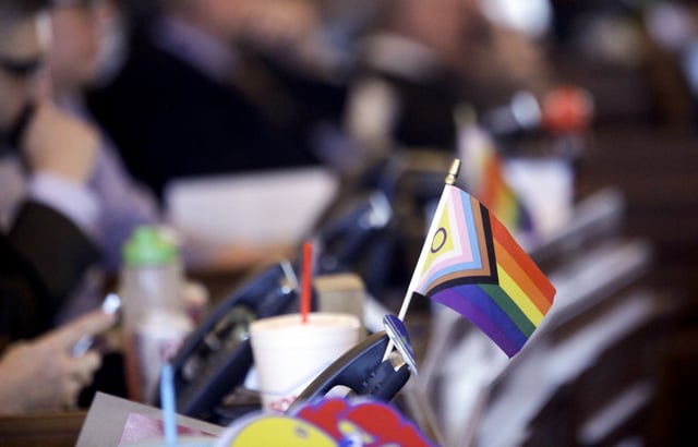 A flag supporting LGBTQ+ rights decorates a desk on the Democratic side of the Kansas House of Representatives during a debate, March 28, 2023, at the Statehouse in Topeka, Kan. The U.S. Supreme Court agreed Monday to consider whether a Tennessee ban on gender-affirming care for minors is constitutional. (AP Photo/John Hanna, File)