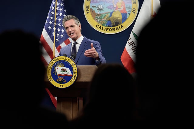 Gov. Gavin Newsom talks to reporters as he unveils his revised 2024-25 budget proposal at the Capitol Annex Swing Space in Sacramento on May 10, 2024. Photo by Fred Greaves for CalMatters